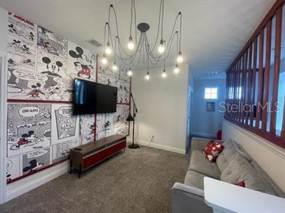 166 Captiva Drive Davenport, FL 33896 - Photo 6 of 8 a living room with furniture and a flat screen tv