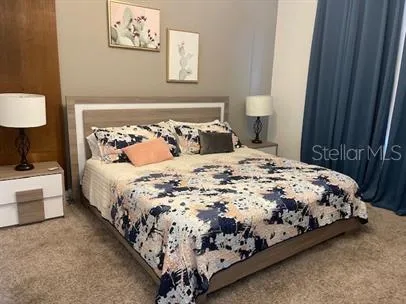 a large bed sitting in a bedroom next to a wooden floor