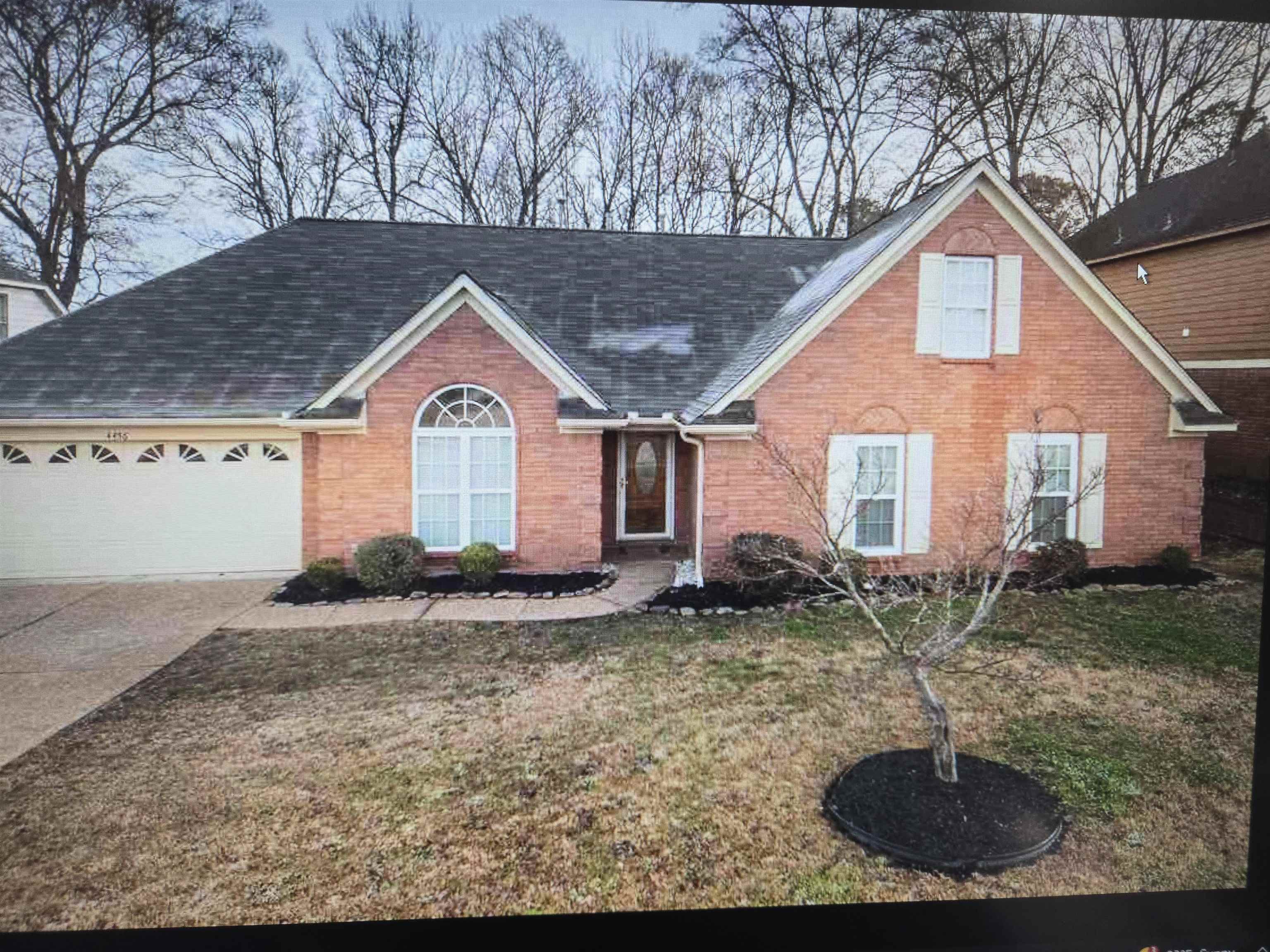 4456 Long Creek Road Memphis, TN 38125 - Photo 1 of 1 Brick exterior featuring a gabled roof and white window shutters