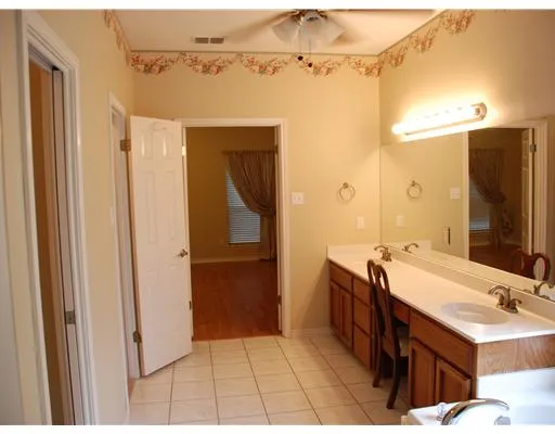 a view of a livingroom with wooden floor and a cabinet