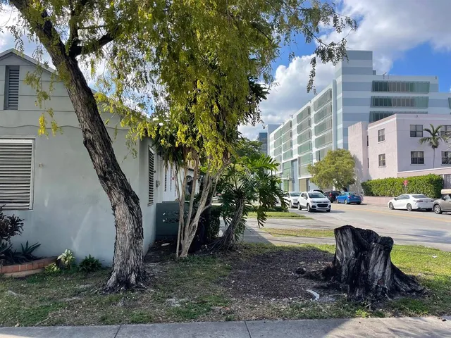 a view of a backyard with a table and chairs