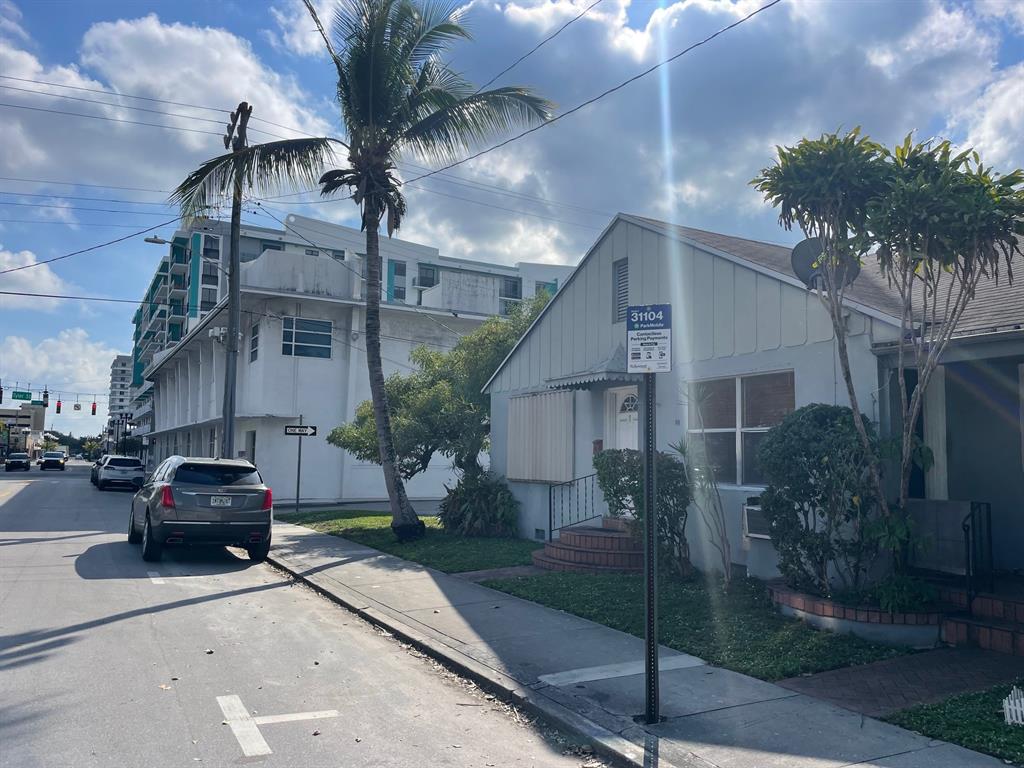 2000 Polk Street Hollywood, FL 33020 - Photo 5 of 7 a city street lined with buildings and cars parked on road