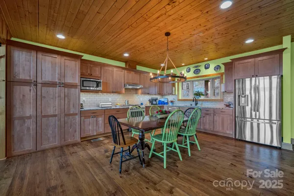 a dining room with furniture and wooden floor