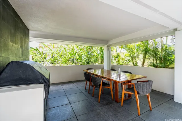 a view of a dining room with furniture and a large window