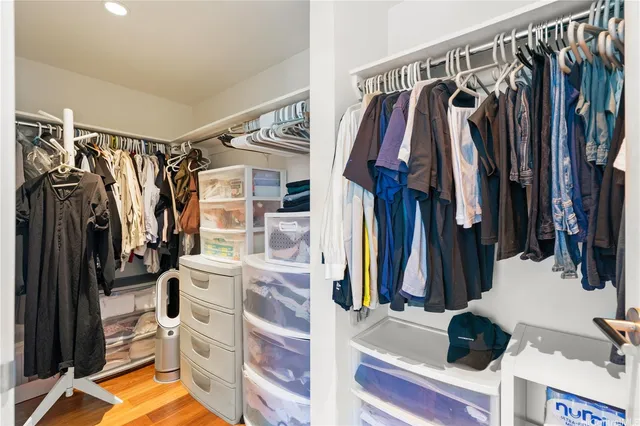 a view of walk in closet with clothes and shoes