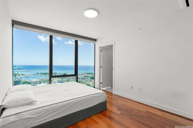 a bed sitting in a bedroom next to a large window