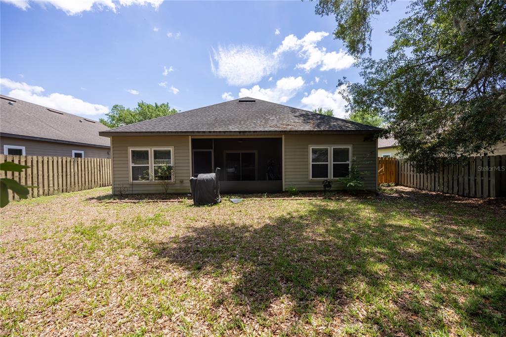 7550 Southwest 81st Way Gainesville, FL 32608 - Photo 26 of 31 a front view of a house with a garden