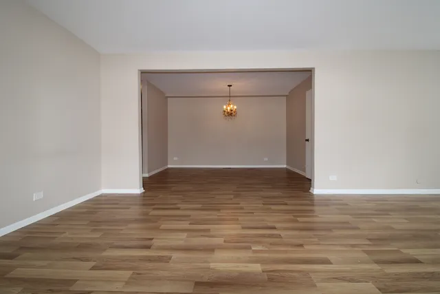 a view of room with wooden floor