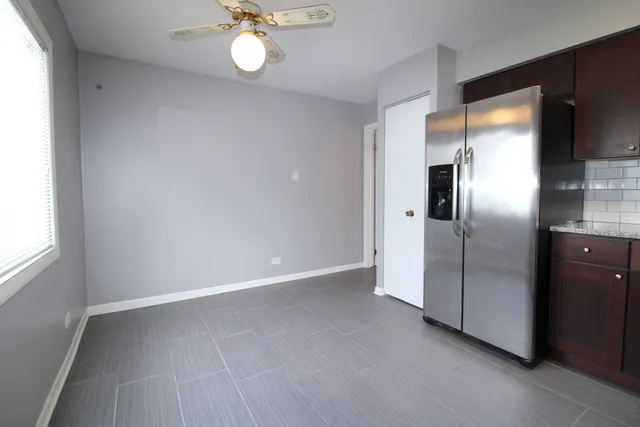 a view of an empty room with a fan