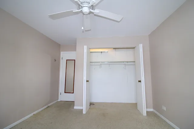 an empty room with a empty space and chandelier fan