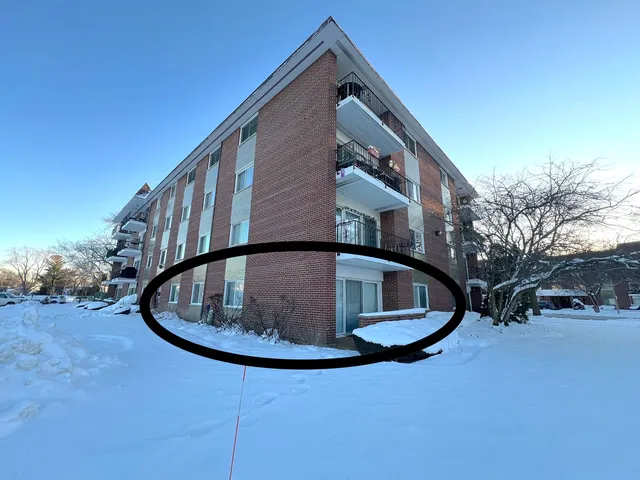 a view of staircase with white walls and a wooden floor