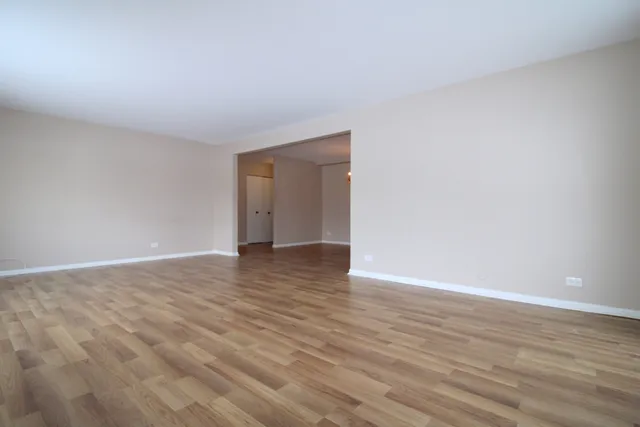 a view of an empty room and wooden floor