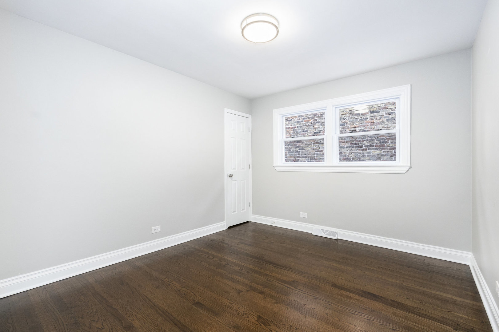 1901 West 71st Street Chicago, IL 60636 - Photo 12 of 25 an empty room with wooden floor and windows