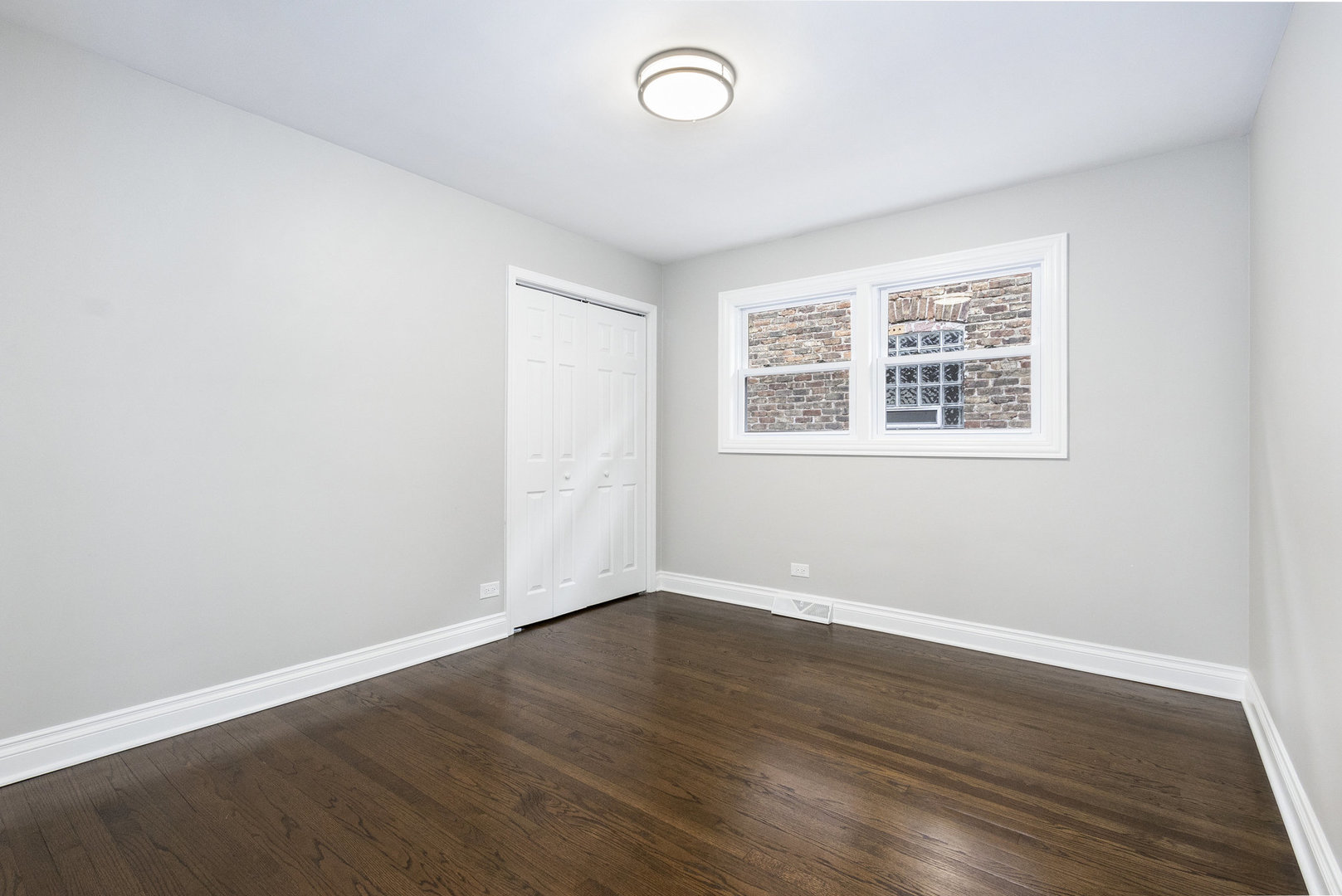 1901 West 71st Street Chicago, IL 60636 - Photo 13 of 25 an empty room with wooden floor and windows