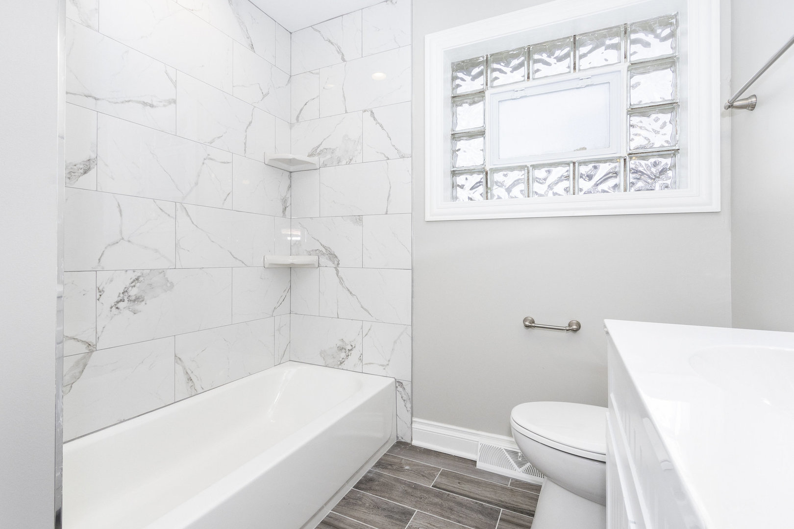 1901 West 71st Street Chicago, IL 60636 - Photo 18 of 25 a bathroom with a bathtub and a toilet