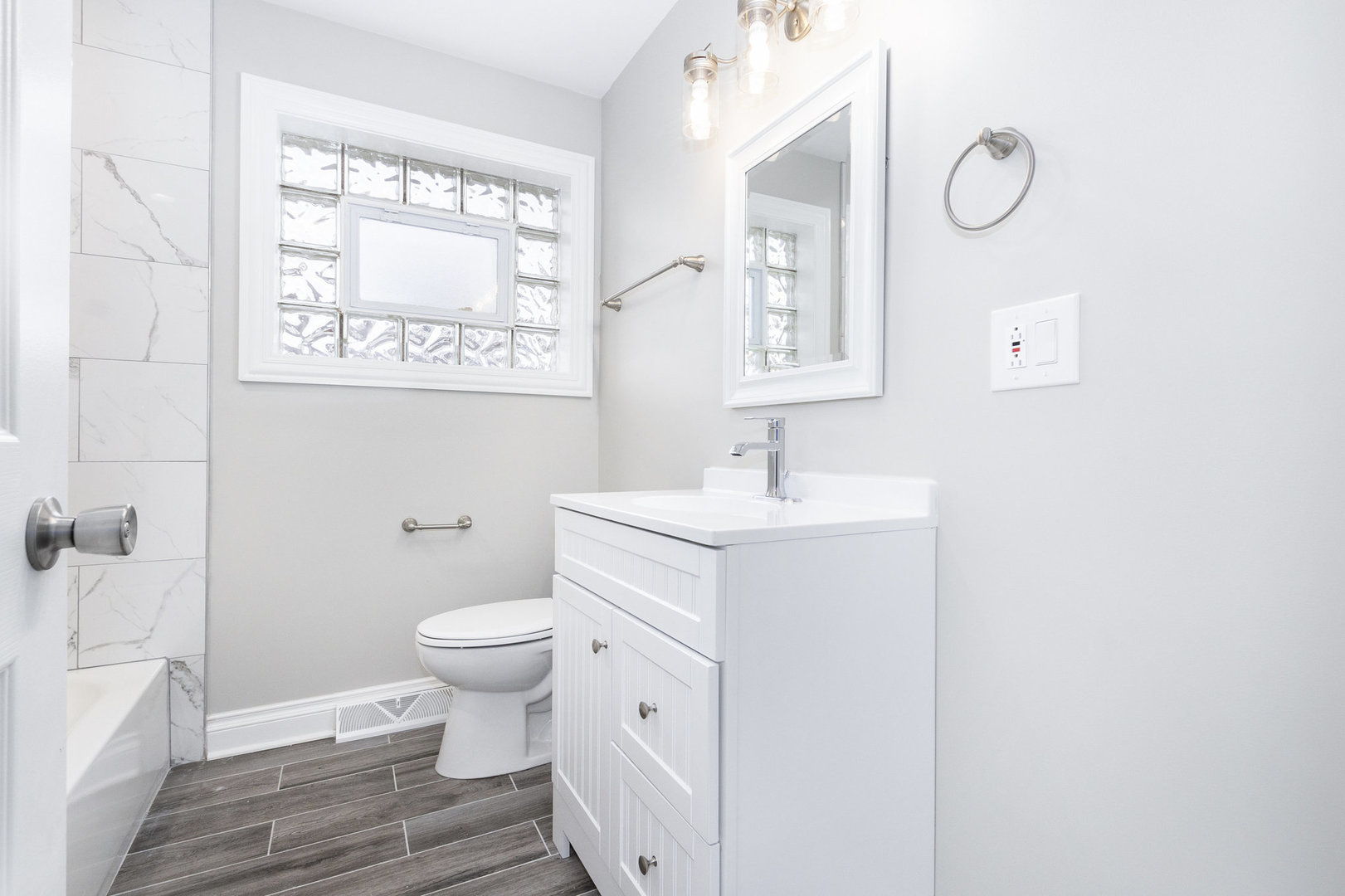 1901 West 71st Street Chicago, IL 60636 - Photo 19 of 25 a bathroom with a sink a toilet and a mirror