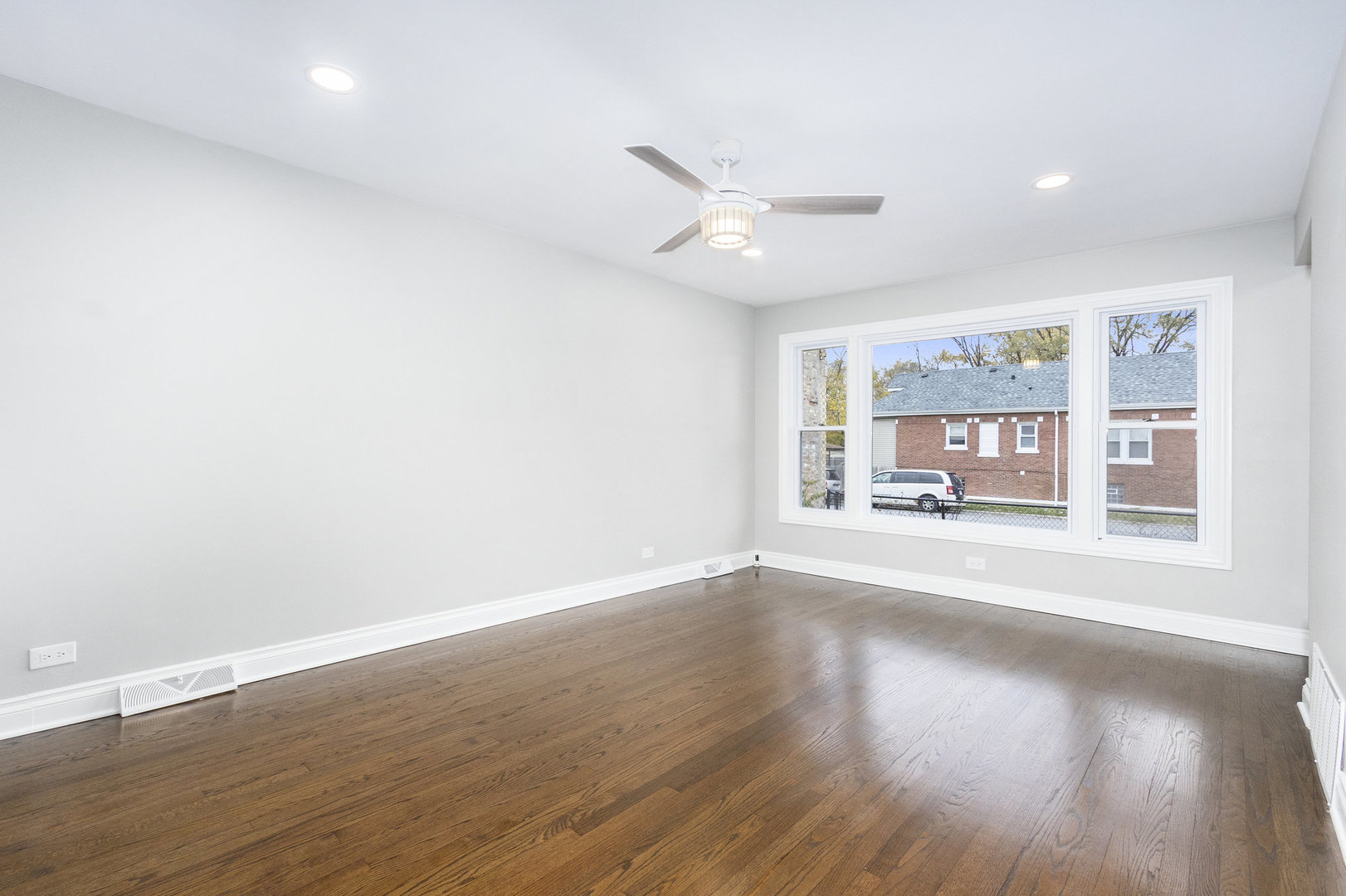 1901 West 71st Street Chicago, IL 60636 - Photo 3 of 25 an empty room with wooden floor and windows