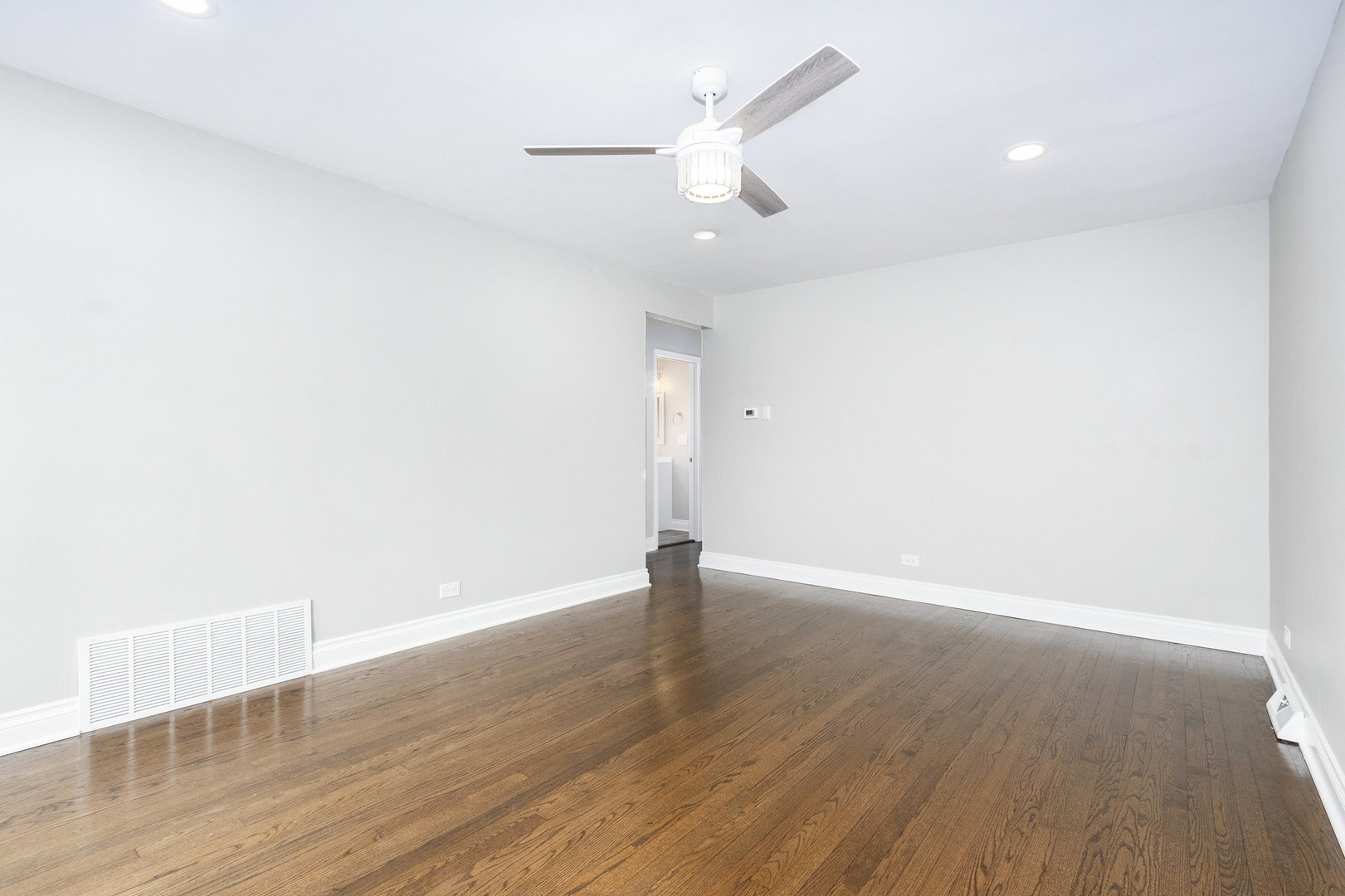 1901 West 71st Street Chicago, IL 60636 - Photo 4 of 25 an empty room with wooden floor and windows