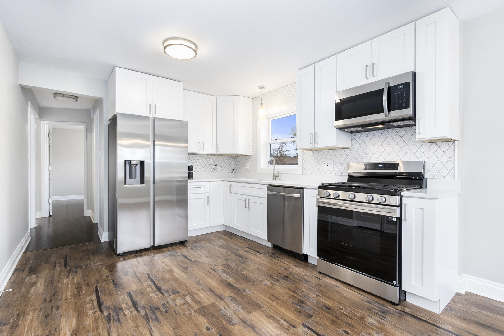 1901 West 71st Street Chicago, IL 60636 - Photo 5 of 25 a kitchen with stainless steel appliances a stove a sink and a microwave