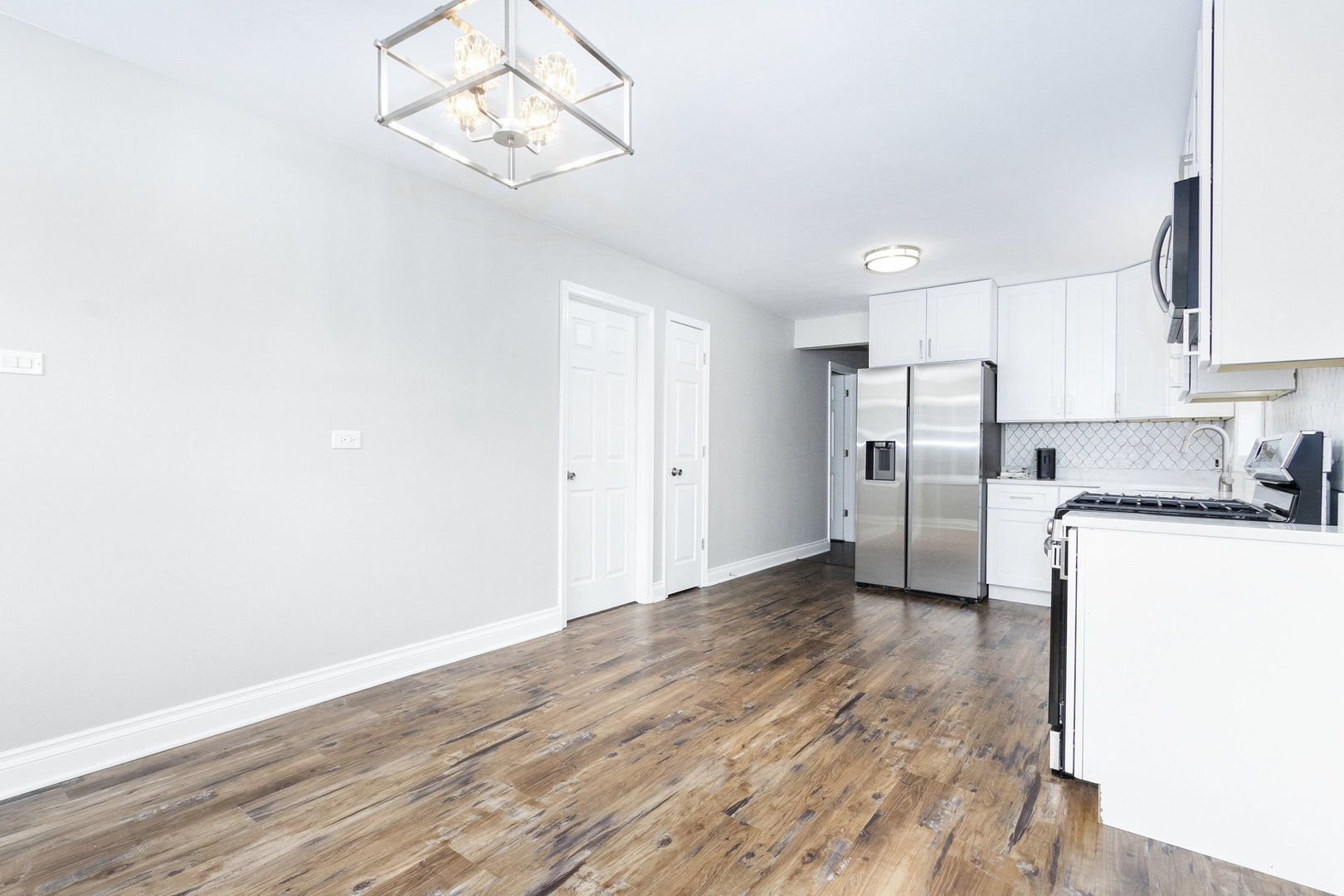 1901 West 71st Street Chicago, IL 60636 - Photo 6 of 25 a view of a kitchen with a sink a refrigerator and wooden floor