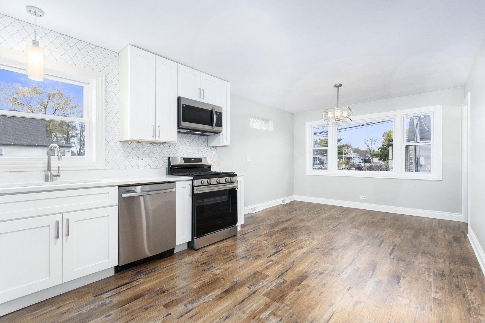 1901 West 71st Street Chicago, IL 60636 - Photo 7 of 25 a kitchen with granite countertop a stove a sink and a microwave
