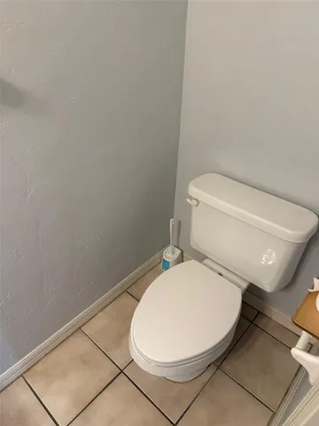 a white toilet sitting next to a white sink