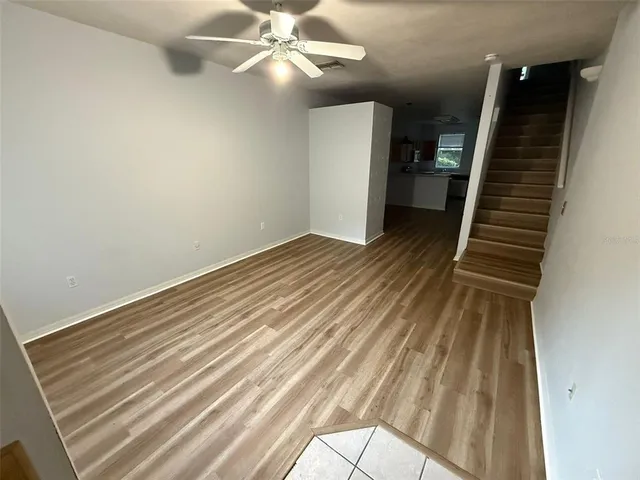 a view of an empty room with wooden floor