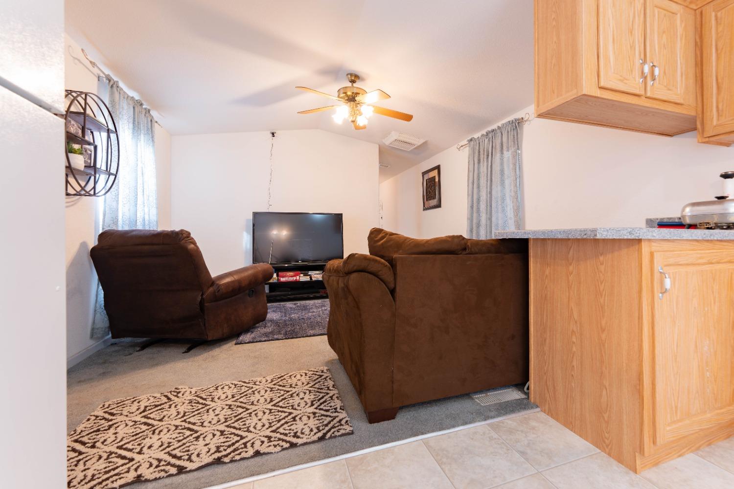 40778 Iris Road Squaw Valley, CA 93675 - Photo 12 of 44 a living room with furniture and a chandelier