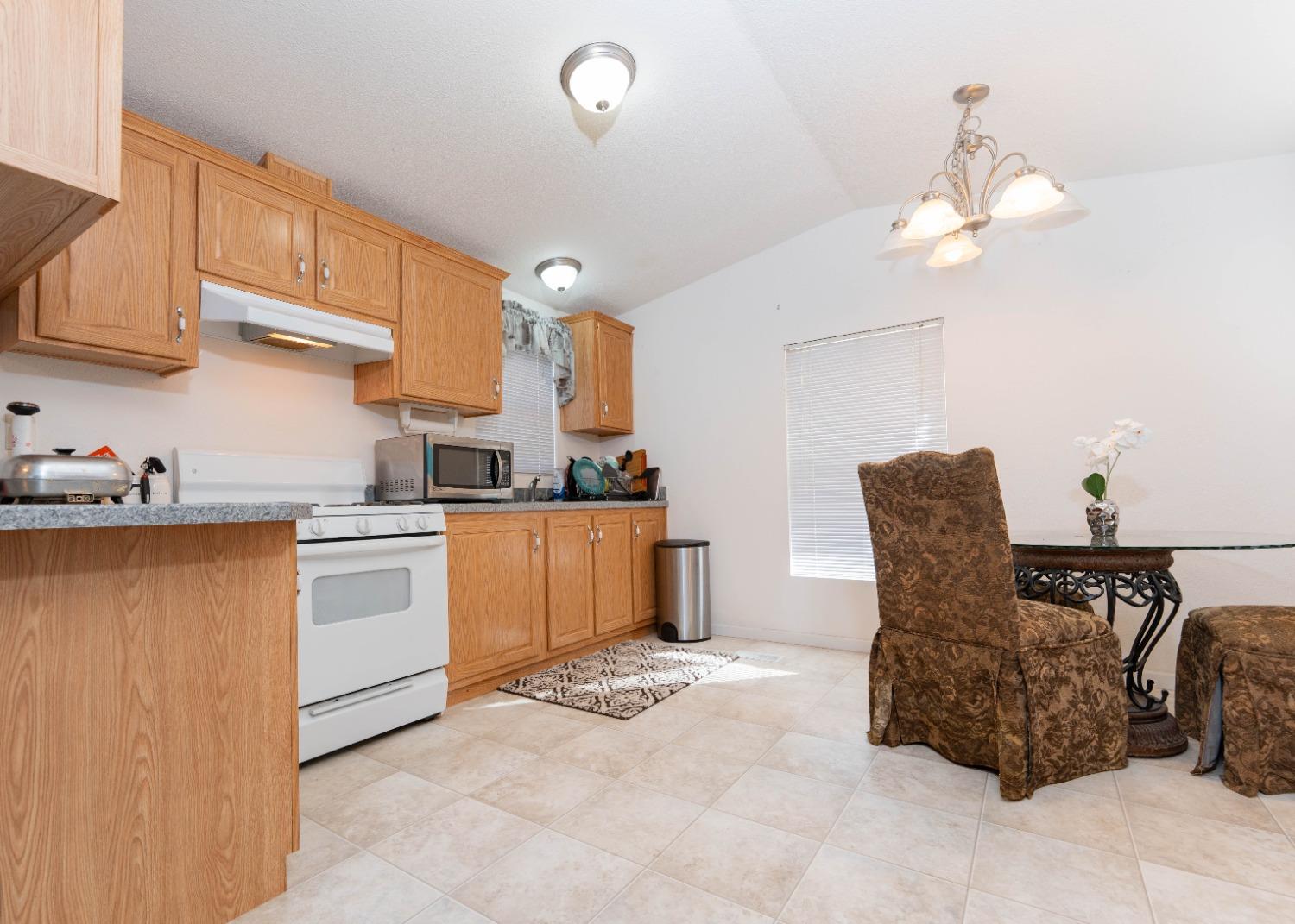 40778 Iris Road Squaw Valley, CA 93675 - Photo 13 of 44 a kitchen with cabinets and chairs
