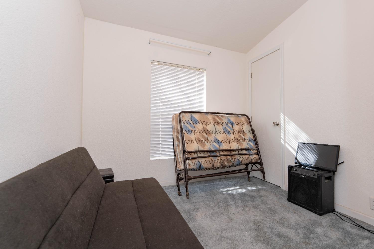 40778 Iris Road Squaw Valley, CA 93675 - Photo 17 of 44 a bedroom with a bed and a chair