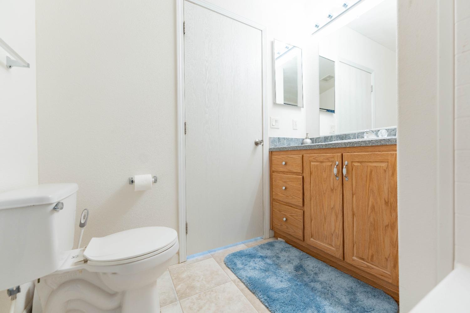 40778 Iris Road Squaw Valley, CA 93675 - Photo 20 of 44 a bathroom with a granite countertop sink mirror vanity and toilet