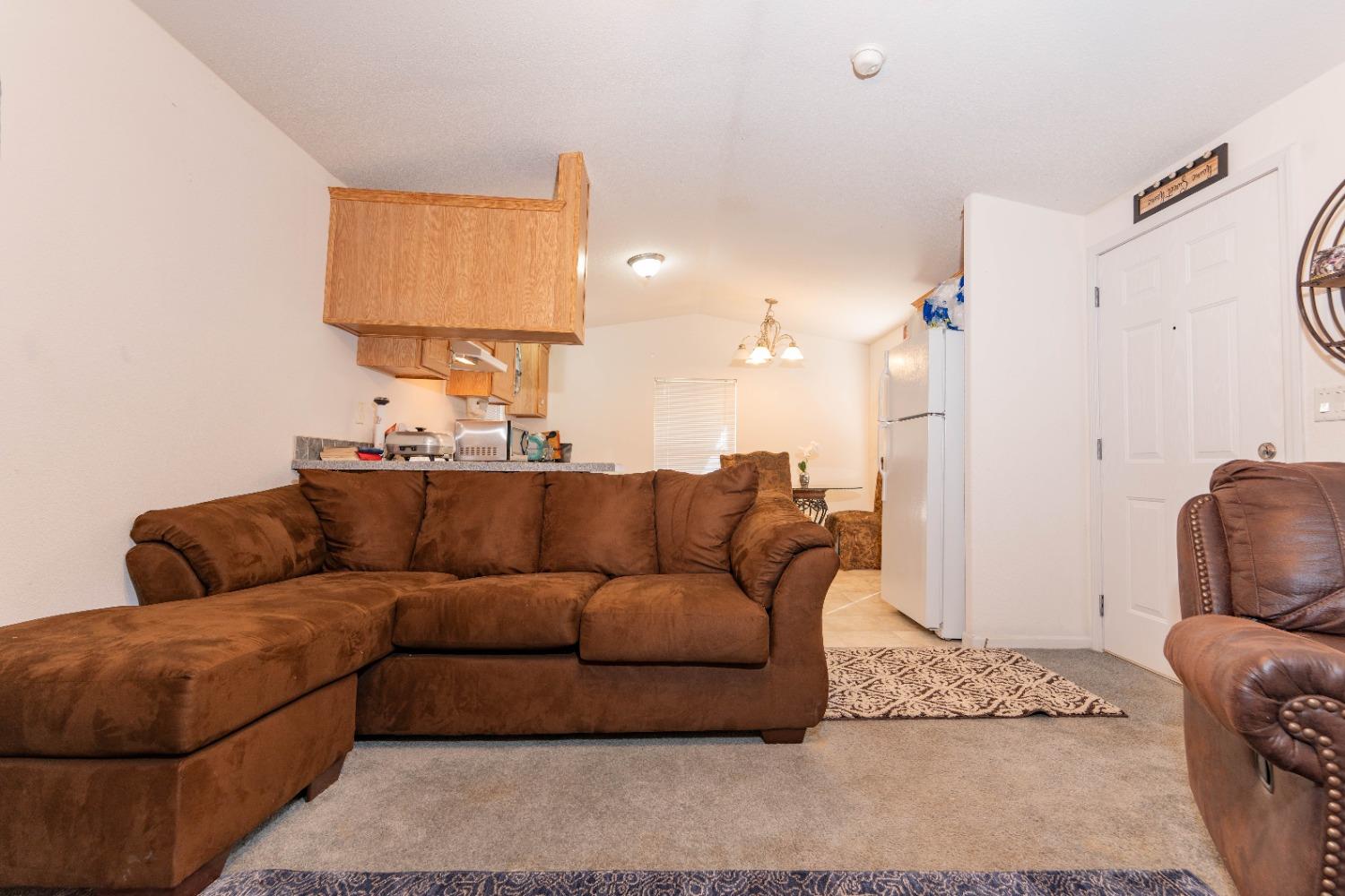40778 Iris Road Squaw Valley, CA 93675 - Photo 10 of 44 a living room with furniture and a lamp