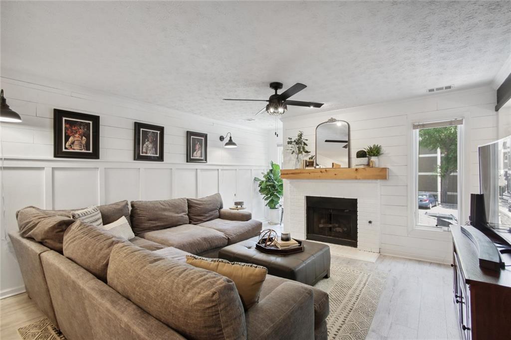 a living room with furniture and a fireplace