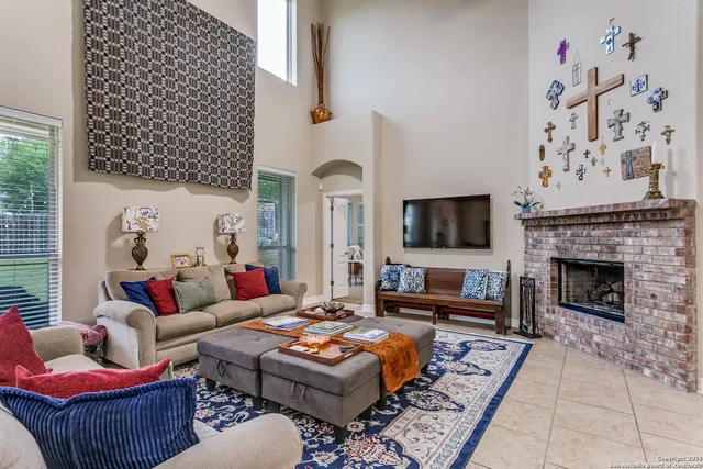 a living room with furniture a flat screen tv and a fireplace