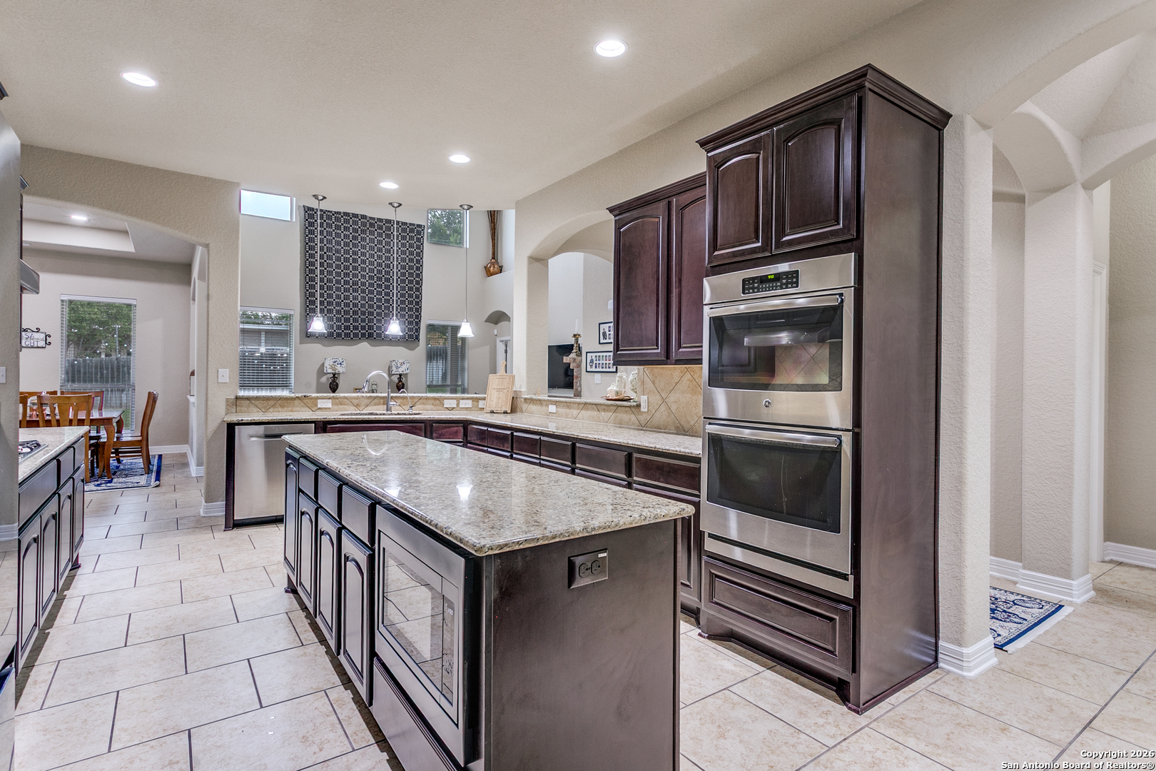701 Morningside Drive Terrell Hills, TX 78209 - Photo 16 of 47 a kitchen with stainless steel appliances granite countertop a stove a sink and a refrigerator
