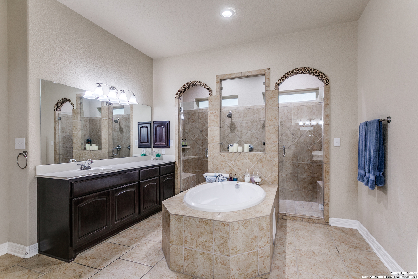 701 Morningside Drive Terrell Hills, TX 78209 - Photo 22 of 47 a spacious bathroom with a granite countertop sink a toilet a mirror and shower