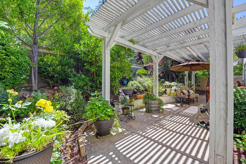 a view of a porch with chairs and potted plants