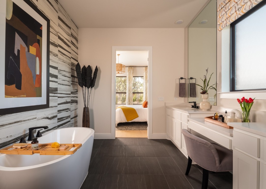 2002 Clearlight Lane Georgetown, TX 78633 - Photo 11 of 30 Bathroom with a freestanding tub, vanity, and an accent wall