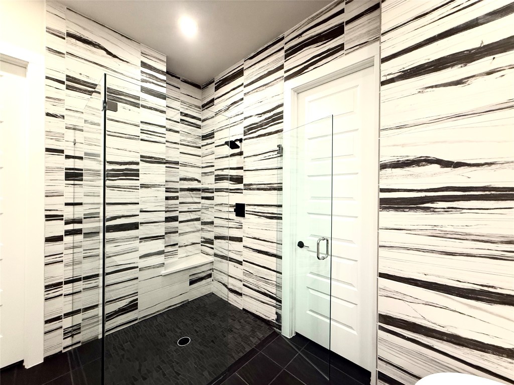 2002 Clearlight Lane Georgetown, TX 78633 - Photo 13 of 30 Full bath featuring a shower stall and dark tile patterned flooring