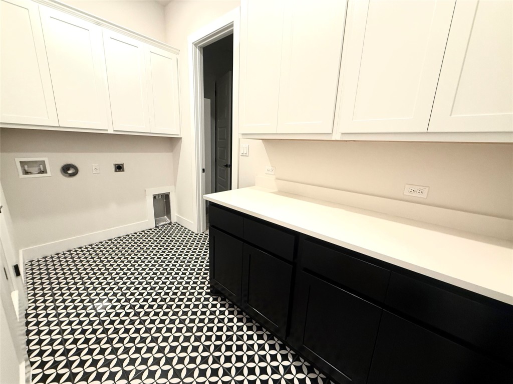 2002 Clearlight Lane Georgetown, TX 78633 - Photo 19 of 30 Laundry area with cabinet space, electric dryer hookup, washer hookup, hookup for a gas dryer, and dark flooring