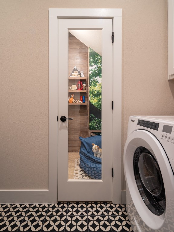 2002 Clearlight Lane Georgetown, TX 78633 - Photo 20 of 30 Laundry area featuring washer / dryer and a textured wall