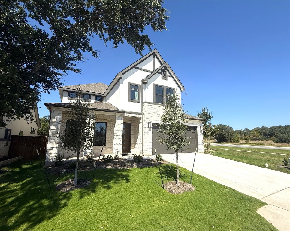 2002 Clearlight Lane Georgetown, TX 78633 - Photo 2 of 30 View of front of house featuring concrete driveway, stone siding, stucco siding, and an attached garage