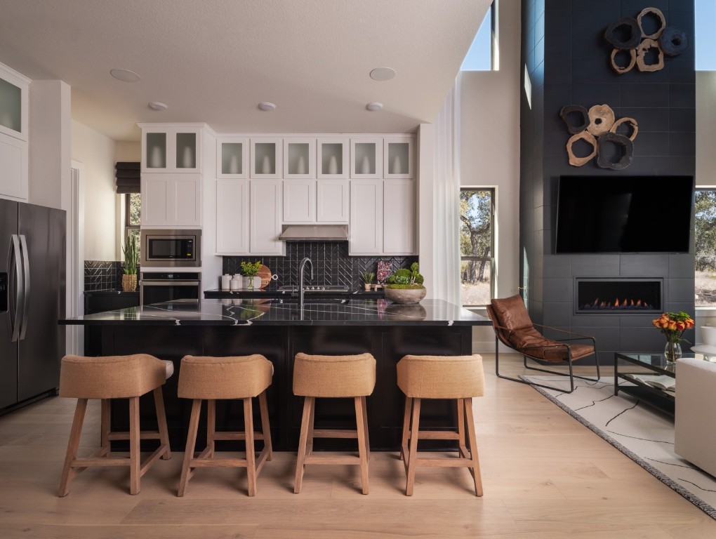 2002 Clearlight Lane Georgetown, TX 78633 - Photo 6 of 30 Kitchen featuring appliances with stainless steel finishes, dark countertops, healthy amount of natural light, and decorative backsplash