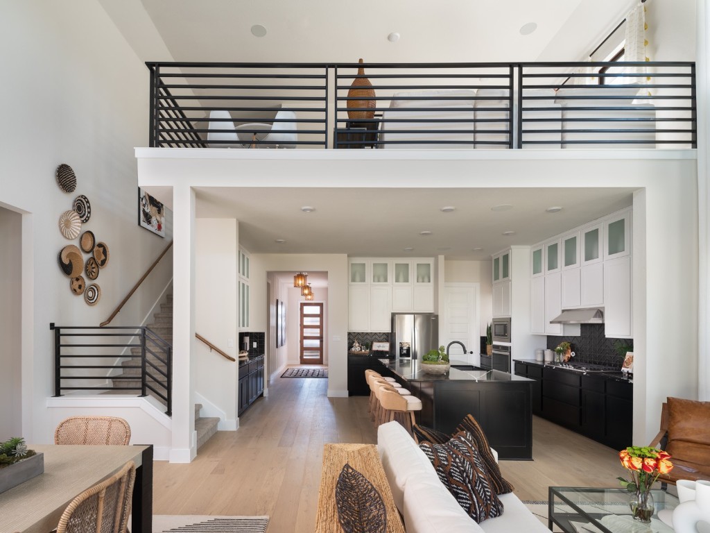 2002 Clearlight Lane Georgetown, TX 78633 - Photo 8 of 30 Living area with light wood-type flooring, stairway, and a towering ceiling