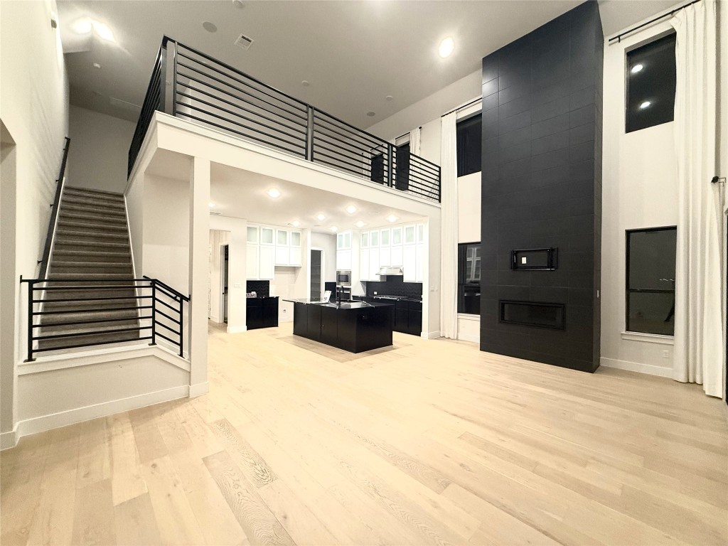 2002 Clearlight Lane Georgetown, TX 78633 - Photo 9 of 30 Living area with an office area, stairs, light wood-style flooring, and recessed lighting