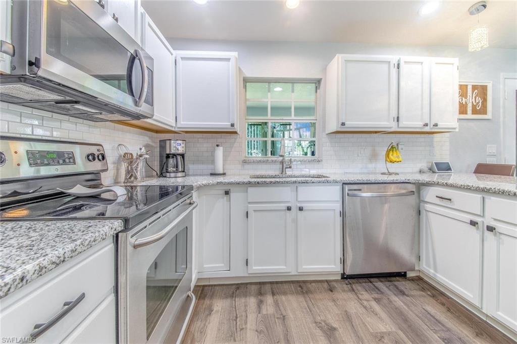 910 Liberty Lane Auburndale, FL 33823 - Photo 13 of 48 a kitchen with stainless steel appliances granite countertop a sink and cabinets