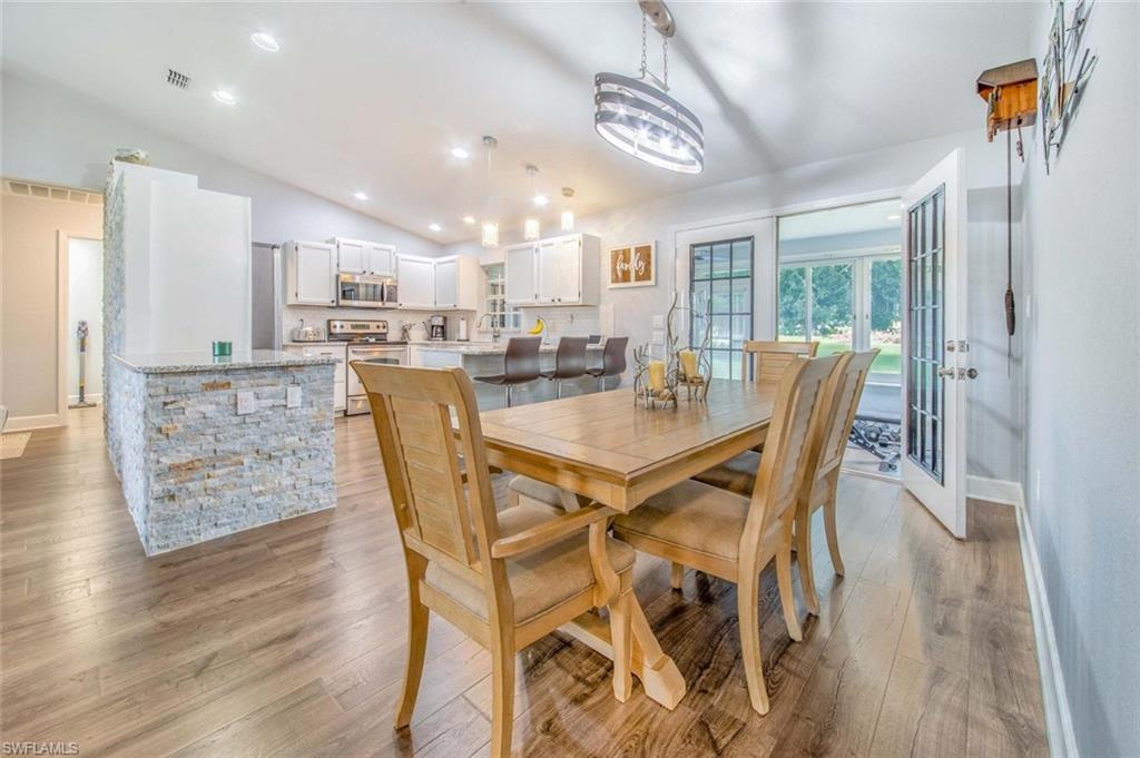 910 Liberty Lane Auburndale, FL 33823 - Photo 21 of 48 a dining room with furniture and wooden floor