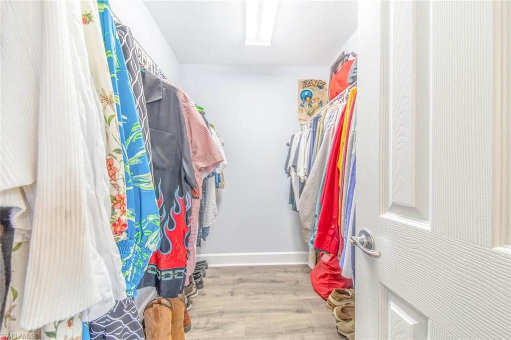 910 Liberty Lane Auburndale, FL 33823 - Photo 26 of 48 a view of walk in closet with clothes