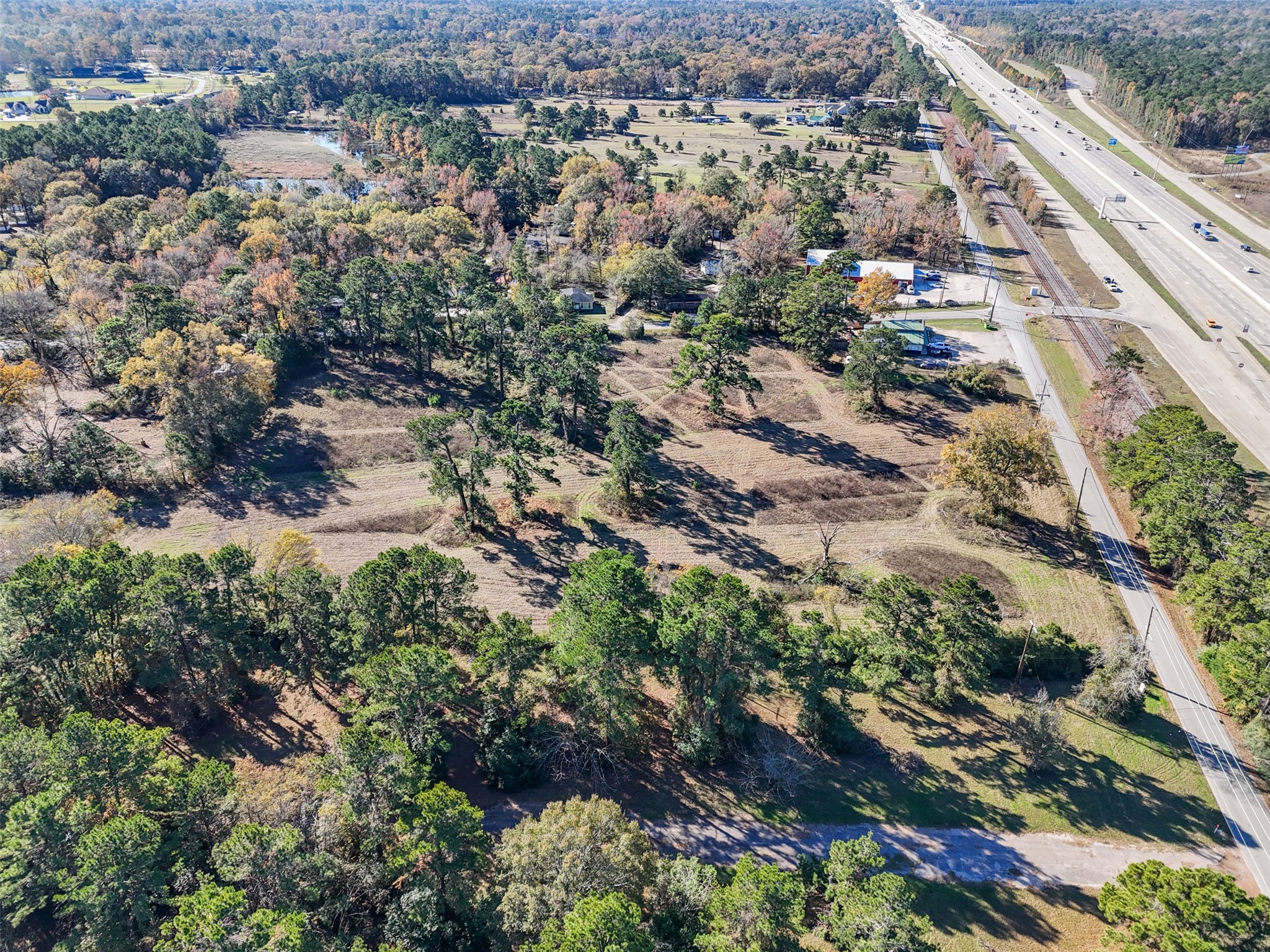 15633 1st Street Splendora, TX 77372 - Photo 2 of 19 an aerial view of residential house with outdoor space and trees all around