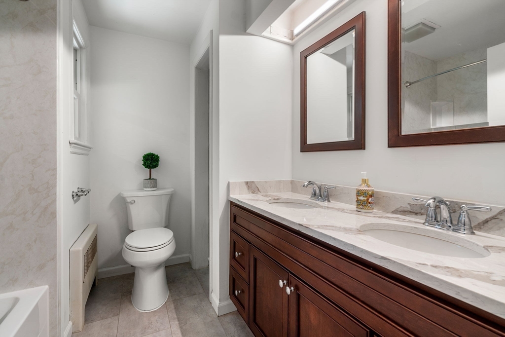 335 Conant Road Weston, MA 02493 - Photo 12 of 31 a bathroom with a granite countertop toilet sink and mirror